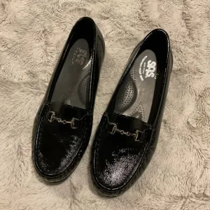 Sas Shiny Black Loafers with Silver Tone Metal Embellishment.